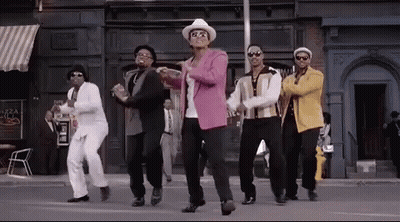 A Group Of Men Are Dancing In Front Of A Building . GIF