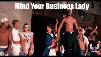 A Group Of Men Are Dancing In Front Of A Building With The Words `` Mind Your Business Lady '' Written Above Them . GIF