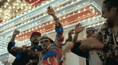 A Group Of Men Are Dancing In Front Of A Colorful Ceiling . GIF