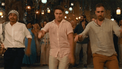 A Group Of Men Are Dancing In Front Of A Crowd Of People At A Party . GIF