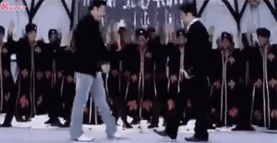 A Group Of Men Are Dancing In Front Of A Crowd Of People . GIF