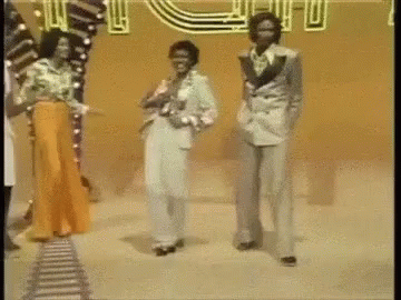 A Group Of Men Are Dancing In Front Of A Sign That Says ' U.s. ' GIF