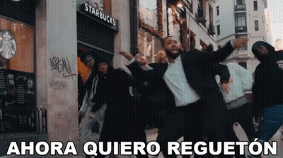 a group of men are dancing in front of a starbucks store