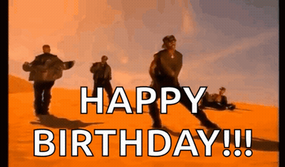 A Group Of Men Are Dancing In The Desert With The Words `` Happy Birthday '' Written In The Foreground . GIF