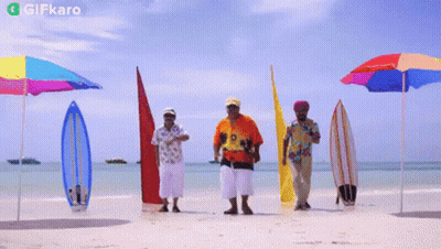 A Group Of Men Are Dancing On A Beach With Surfboards And Umbrellas And A Gifkaro Logo In The Corner GIF