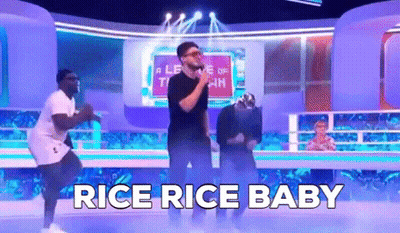 A Group Of Men Are Dancing On A Stage With The Words `` Rice Rice Baby '' Behind Them . GIF