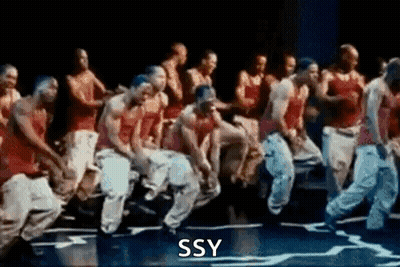 A Group Of Men Are Dancing On A Stage With The Words Ssy Written On The Bottom Of The Image . GIF