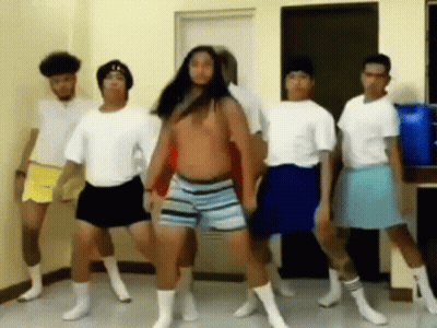 A Group Of Men Are Dancing Together In A Room While Wearing Shorts And Socks . GIF