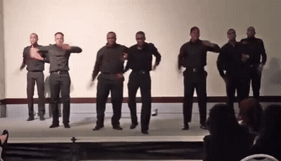 A Group Of Men Are Dancing Together On A Stage GIF