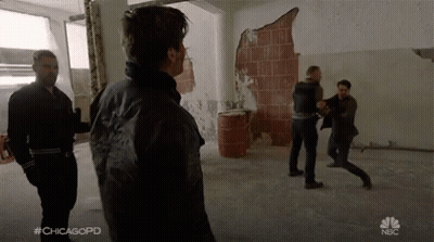 A Group Of Men Are Fighting In A Room With The Hashtag #Chicagopd On The Bottom GIF