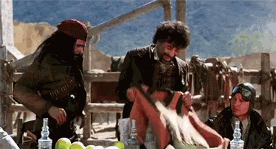 A Group Of Men Are Gathered Around A Table With Bottles Of Alcohol GIF