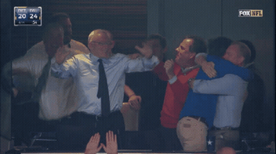 A Group Of Men Are Hugging Each Other In A Fox Nfl Game GIF