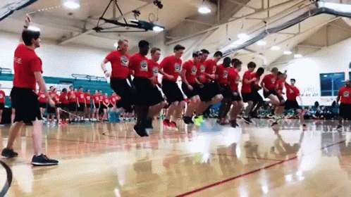 A Group Of Men Are Jumping Rope In A Gym . GIF