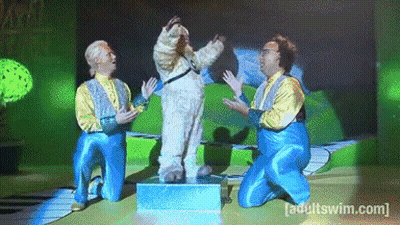 A Group Of Men Are Kneeling In Front Of A Screen That Says [ Adult Swim ] GIF