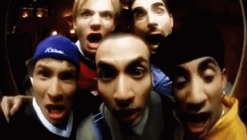 A Group Of Men Are Making Funny Faces For The Camera . GIF