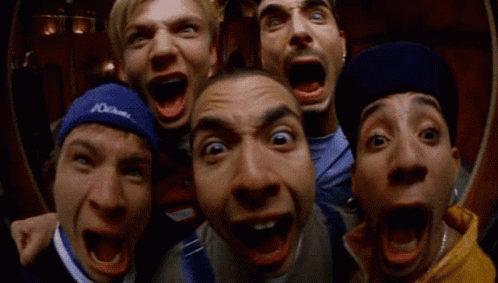 A Group Of Men Are Making Funny Faces With One Wearing A Blue Headband That Says Columbia GIF
