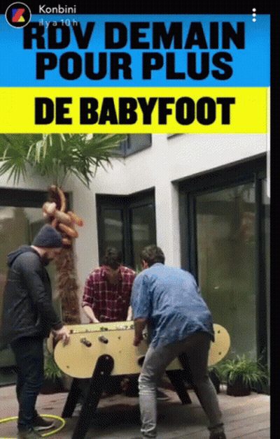 A Group Of Men Are Playing A Game Of Babyfoot Outside GIF
