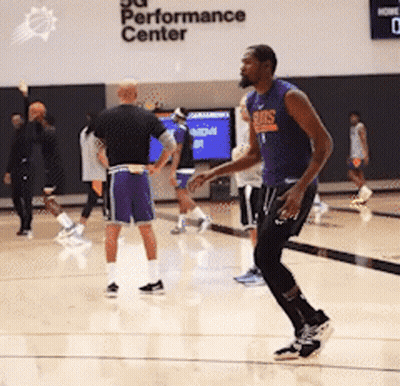 A Group Of Men Are Playing Basketball In A Gym Called The Performance Center GIF
