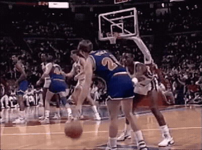 A Group Of Men Are Playing Basketball On A Court . GIF