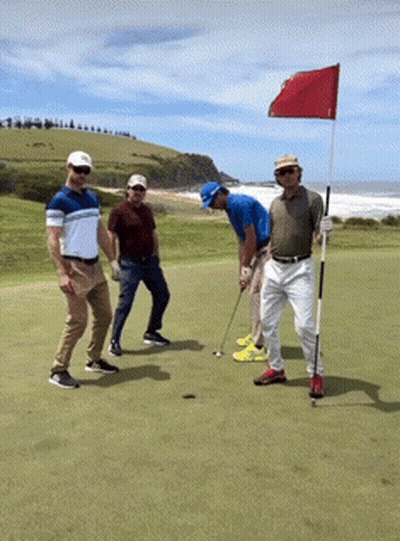 A Group Of Men Are Playing Golf On A Golf Course GIF