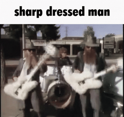 A Group Of Men Are Playing Guitars In A Band . GIF