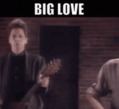 A Group Of Men Are Playing Guitars On A Stage With The Words Big Love Written On The Bottom . GIF