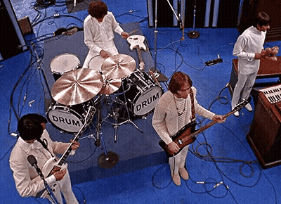A Group Of Men Are Playing Instruments In Front Of A Drum Set That Says Drum On It GIF