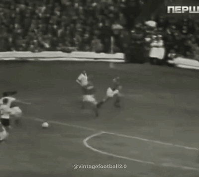 A Group Of Men Are Playing Soccer On A Field . GIF