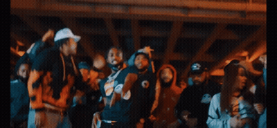 A Group Of Men Are Posing For A Picture And One Of Them Is Wearing A Black Shirt That Says Crew GIF
