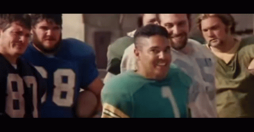 A Group Of Men Are Posing For A Picture And One Of Them Is Wearing A Jersey With The Number 78 On It . GIF