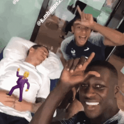 A Group Of Men Are Posing For A Picture And One Of Them Is Wearing A Shirt With The Simpsons On It GIF