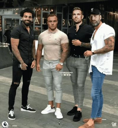 A Group Of Men Are Posing For A Picture In Front Of A Building That Says ' A & B ' On It GIF