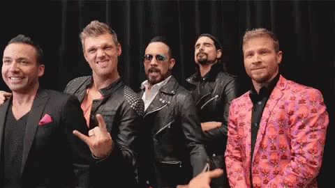 A Group Of Men Are Posing For A Picture Together . GIF