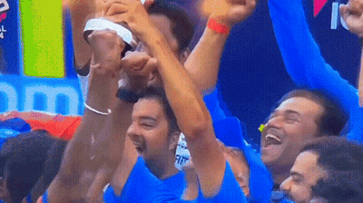 A Group Of Men Are Raising Their Arms In The Air GIF