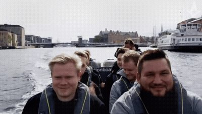 A Group Of Men Are Riding A Boat That Says Pionboa GIF