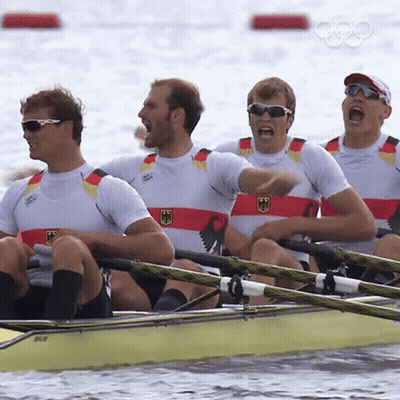 A Group Of Men Are Rowing A Boat And One Of Them Is Wearing A Shirt That Says Germany GIF