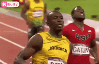 A Group Of Men Are Running On A Track And One Of Them Is Wearing A Jamaica Shirt . GIF