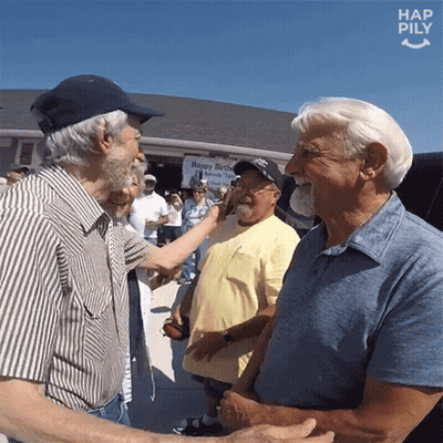 A Group Of Men Are Shaking Hands In Front Of A Sign That Says Happy Birthday GIF