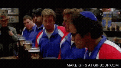 A Group Of Men Are Sitting At A Table And One Of Them Is Making A Surprised Face GIF