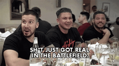 A Group Of Men Are Sitting At A Table With A Caption That Says " Shit Just Got Real In The Battlefield " GIF
