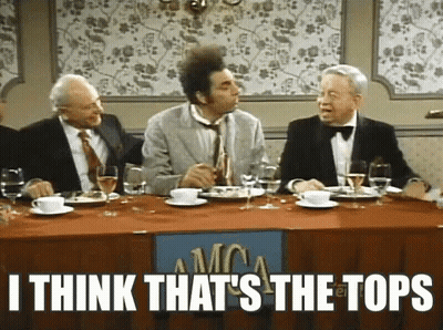 A Group Of Men Are Sitting At A Table With A Sign That Says I Think That 'S The Tops On It . GIF