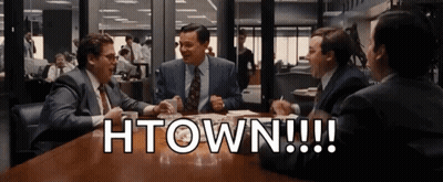 A Group Of Men Are Sitting At A Table With The Words Htown Written On The Table GIF