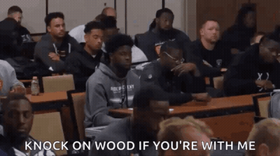 A Group Of Men Are Sitting At Tables In A Classroom With The Words `` Knock On Wood If You 'Re With Me '' GIF