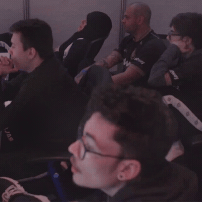 A Group Of Men Are Sitting In A Room And One Of Them Has A Shirt That Says Uae On It GIF