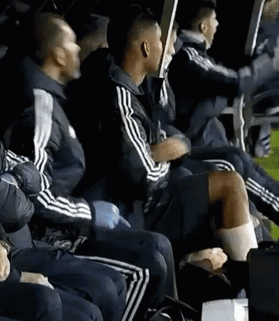 A Group Of Men Are Sitting In A Row Wearing Adidas Jackets GIF