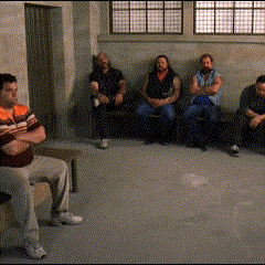 A Group Of Men Are Sitting In A Waiting Room GIF
