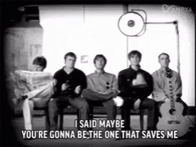 A Group Of Men Are Sitting In Chairs With A Guitar And A Newspaper . GIF