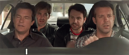 A Group Of Men Are Sitting In The Back Seat Of A Car Looking At Something . GIF