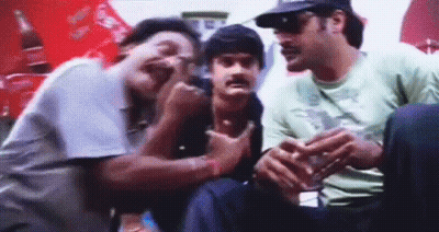 A Group Of Men Are Sitting Next To Each Other In A Room . GIF
