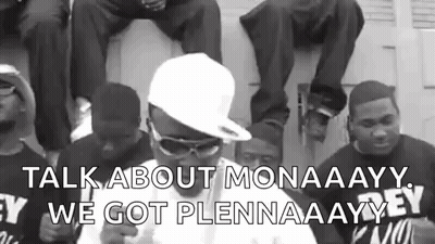 A Group Of Men Are Sitting On Top Of A Garage Door And Talking To Each Other . GIF